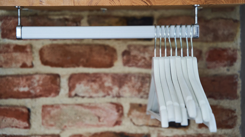 hangers hanging on a metal hanging extender