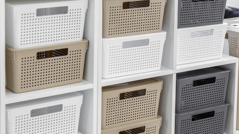 stackable plastic drawers in tan, white, and gray on white shelves for storage in closets