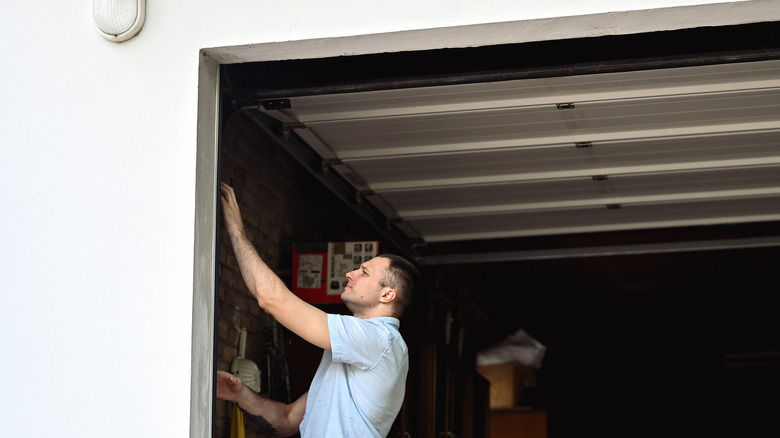 guy fixing a garage door