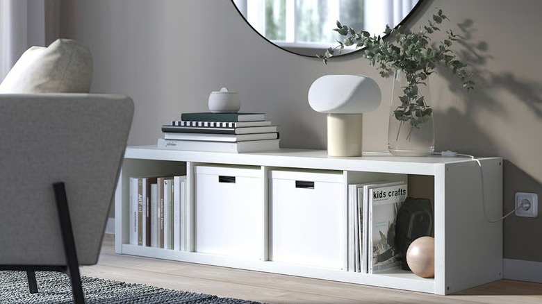 IKEA KALLAX four cube shelf in living room with books and bins